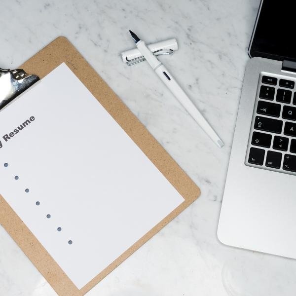 resume and the laptop on the desk